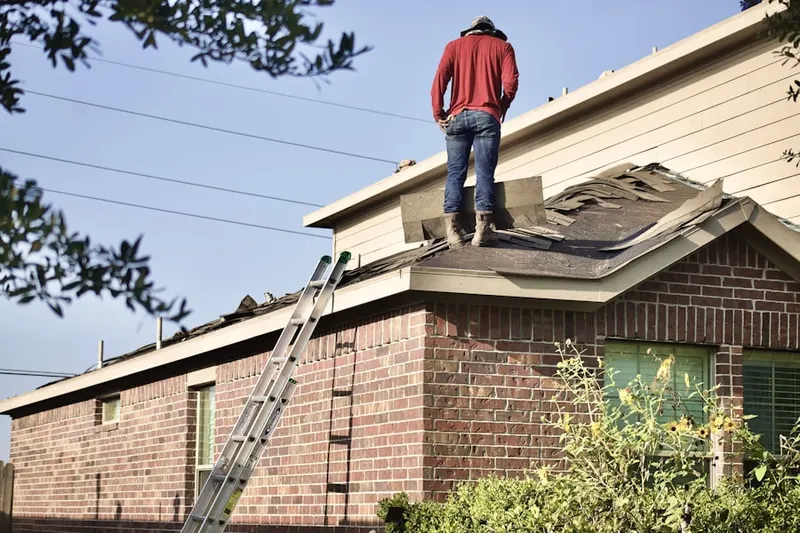 Professional roofer working on a residential roof in Penn Square